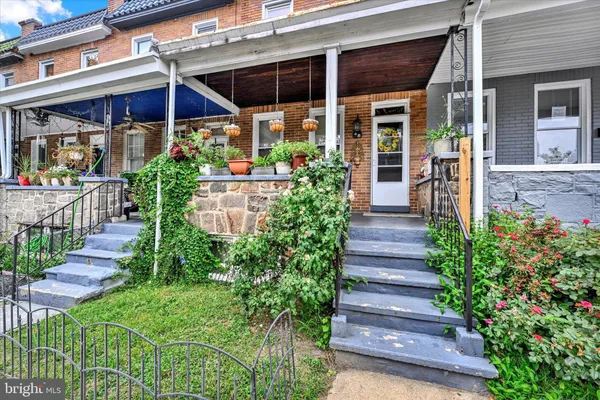 a view of a house with potted plants