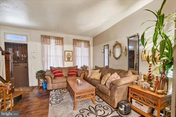 a living room with furniture a rug and a window