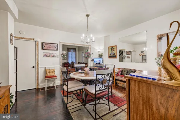 a view of a a dining room with furniture window and wooden floor