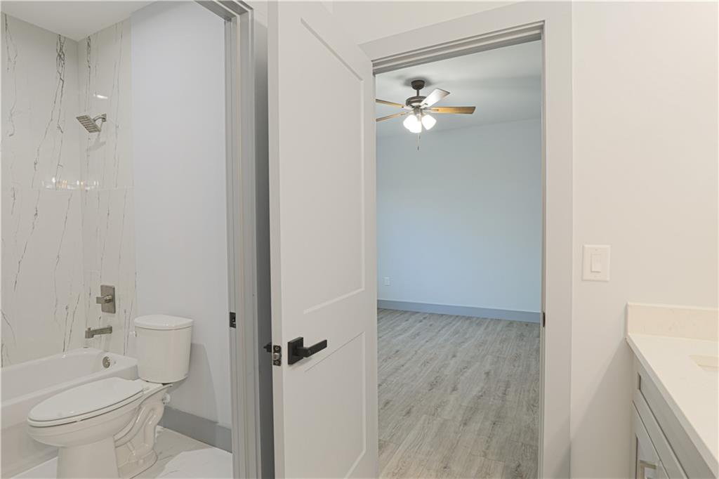1341 Wheeler Creek Road Maysville, GA 30558 - Photo 39 of 51 a bathroom with a toilet a sink and mirror
