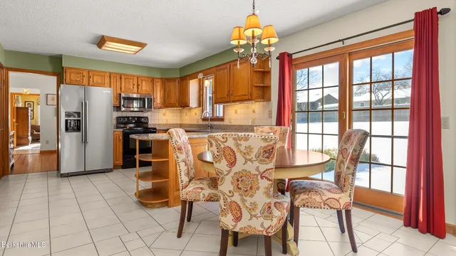 a kitchen with stainless steel appliances kitchen island granite countertop a refrigerator and a stove top oven