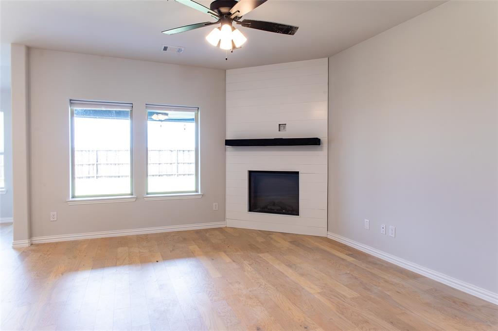 2604 Freeman Street Anna, TX 75409 - Photo 3 of 18 an empty room with windows and fireplace