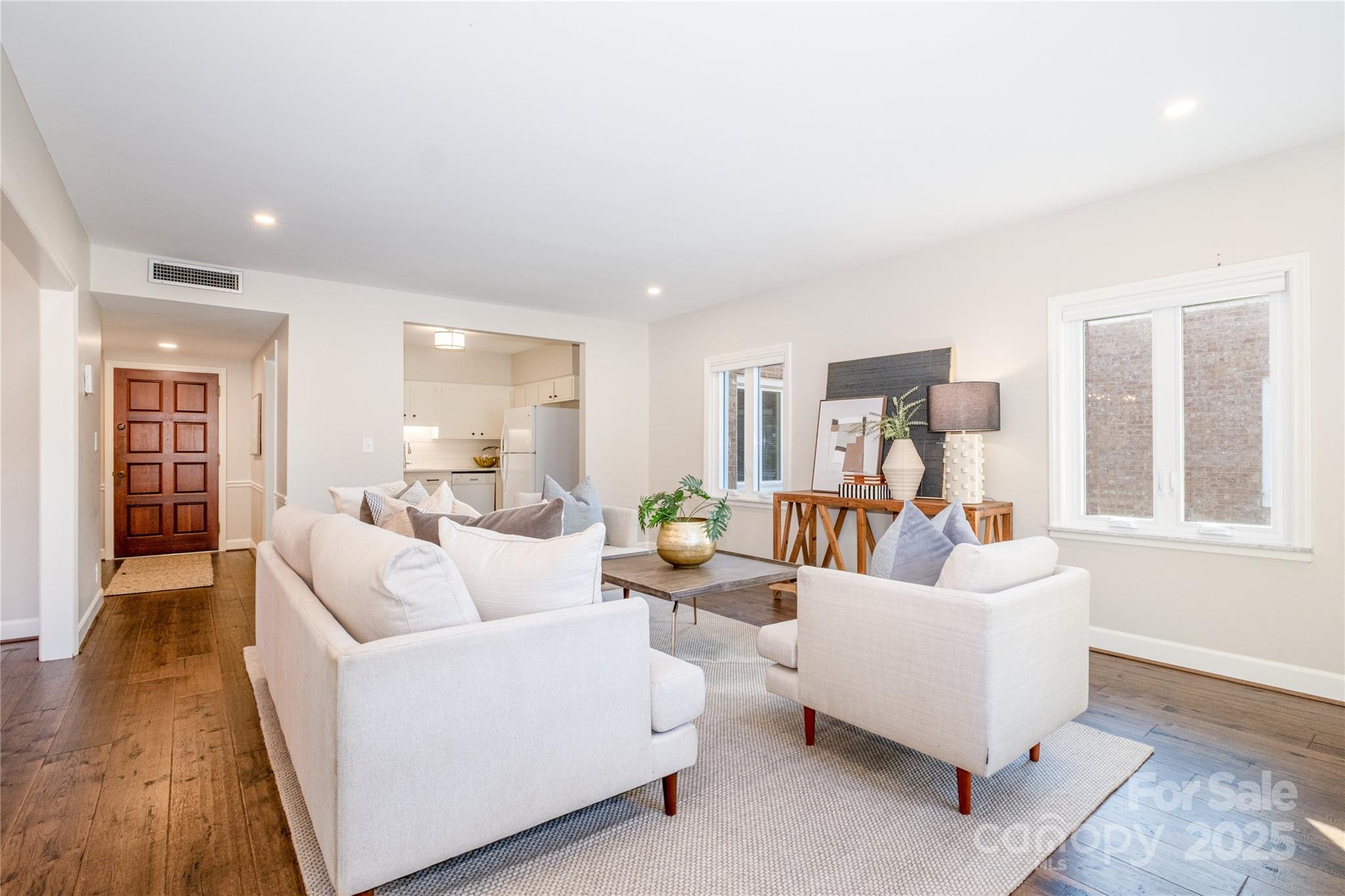 4527 Gaynor Road, Unit 303 Charlotte, NC 28211 - Photo 11 of 28 a living room with furniture and a wooden floor