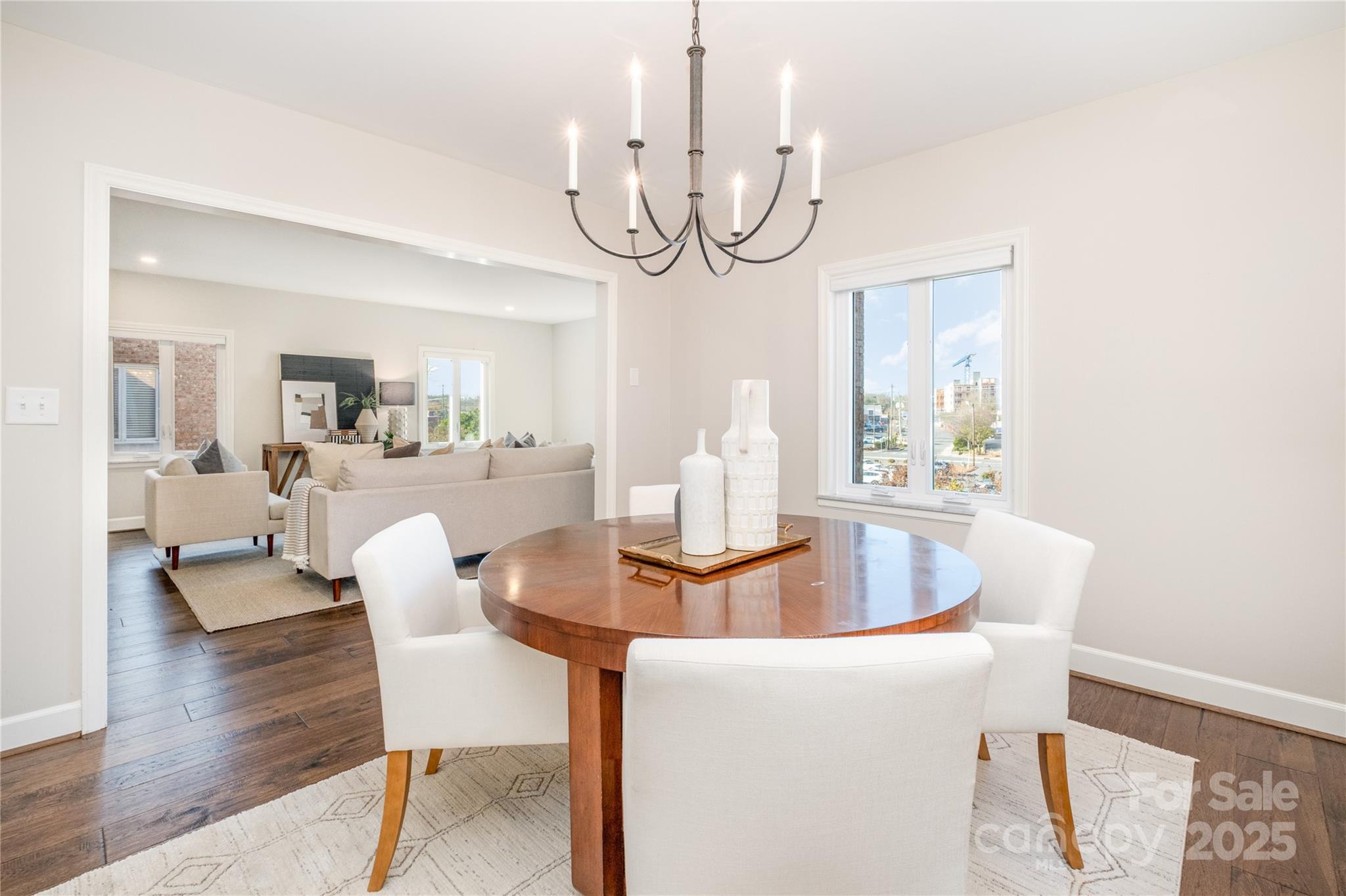 4527 Gaynor Road, Unit 303 Charlotte, NC 28211 - Photo 15 of 28 a view of a dining room with furniture a chandelier and wooden floor