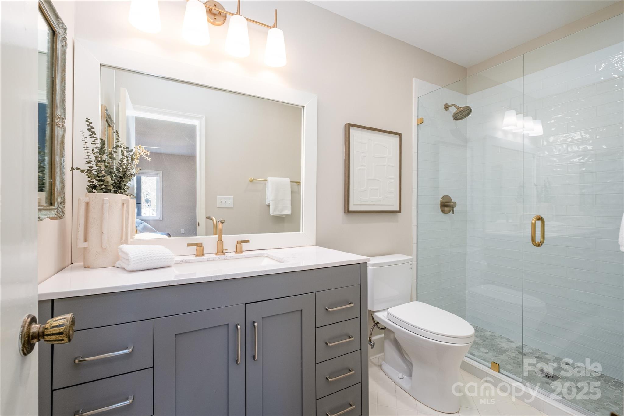 4527 Gaynor Road, Unit 303 Charlotte, NC 28211 - Photo 19 of 28 a bathroom with a sink a toilet and shower
