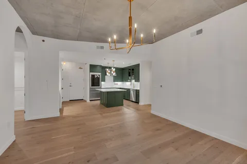 a view of a kitchen with a sink and chandelier fan