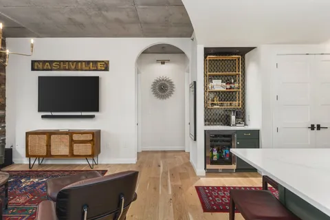 a living room with furniture and a flat screen tv