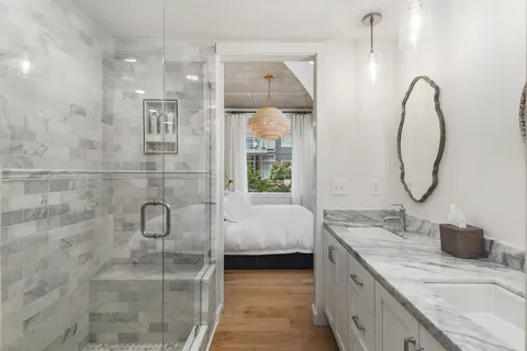 a bathroom with a double vanity sink and a mirror