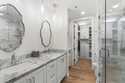 a spacious bathroom with a double vanity sink mirror and double
