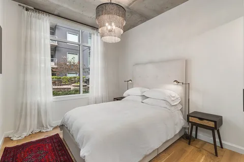 a bedroom with a bed and a chandelier