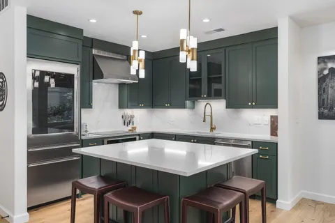 a kitchen with a table a sink and cabinets