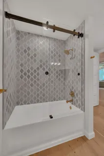 a bathroom with a bathtub and a shower