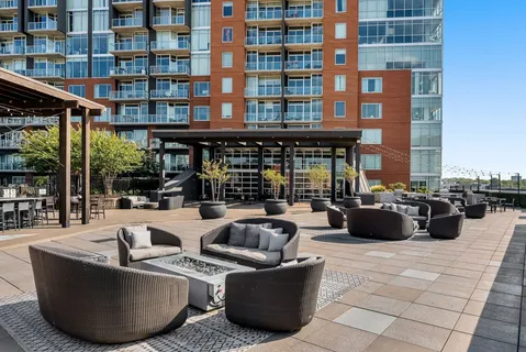 a view of a roof deck with couches and potted plants