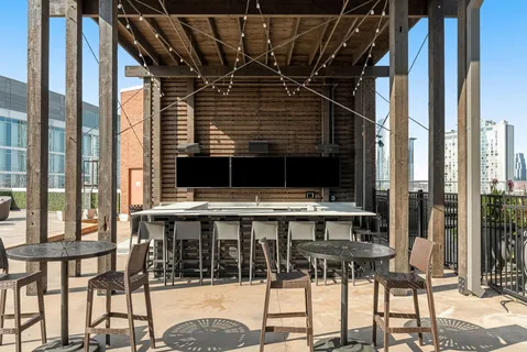 a kitchen with a table chairs and refrigerator