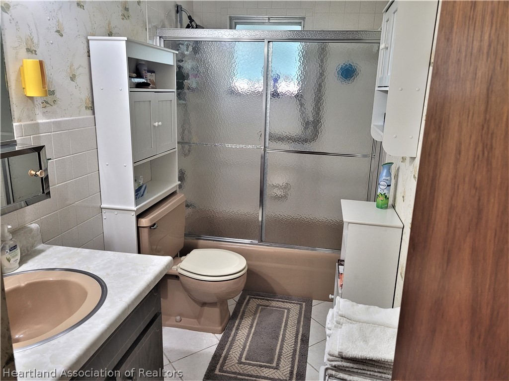 641 South Lakeview Road Lake Placid, FL 33852 - Photo 8 of 15 a white toilet sitting next to a bathroom sink and a shower