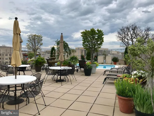 a view of a patio with table and chairs and potted plants