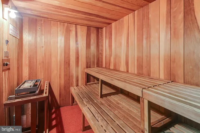 a view of a room with chairs wooden floor and walls