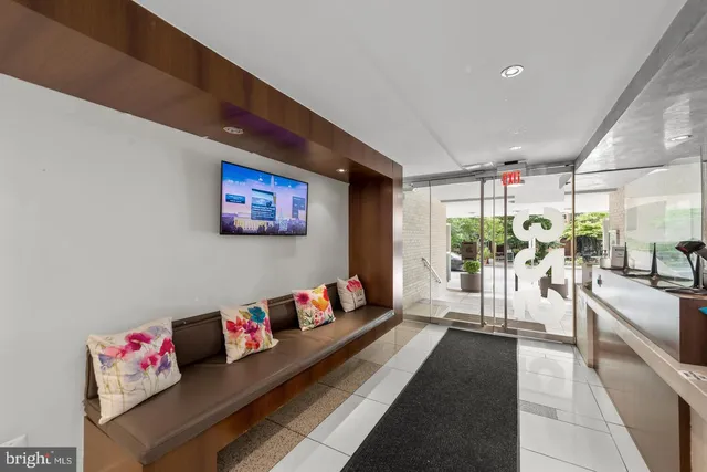 a hallway with a couch and a large window