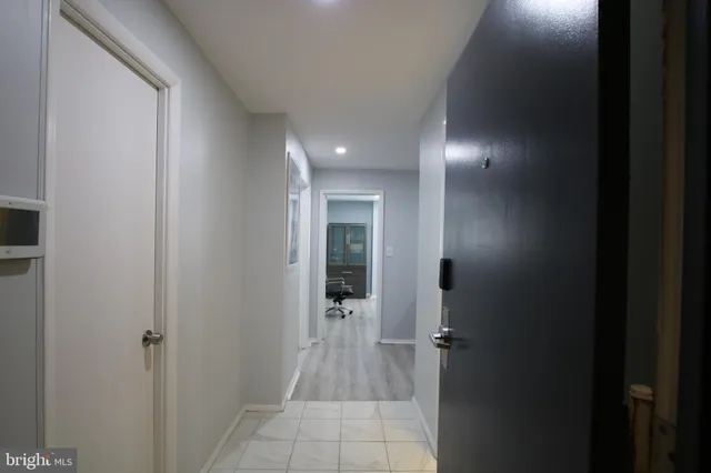 a view of a hallway with wooden shelves