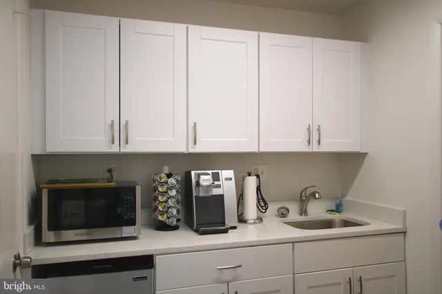 a kitchen with a sink and cabinets