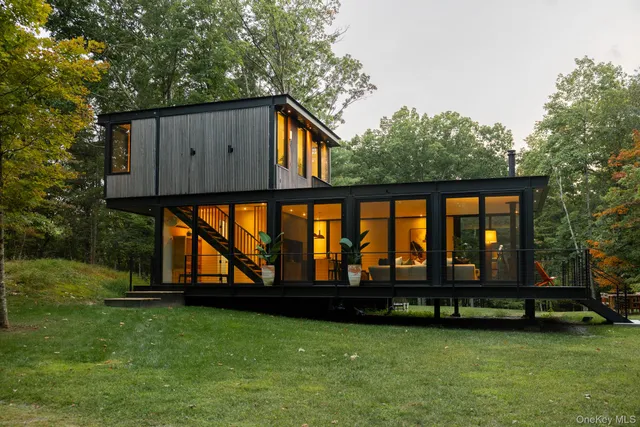 a living room with furniture and floor to ceiling windows