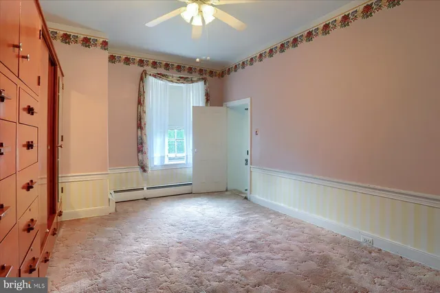 a view of an empty room with a fireplace