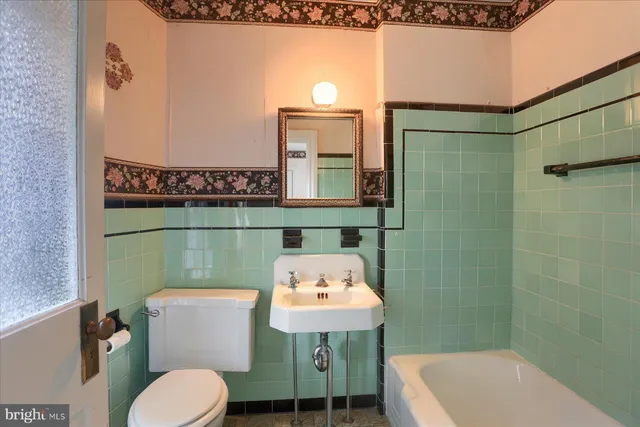 a bathroom with a sink a toilet and a bathtub