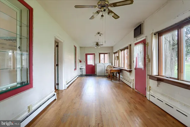 a view of a hallway with wooden floor and staircase