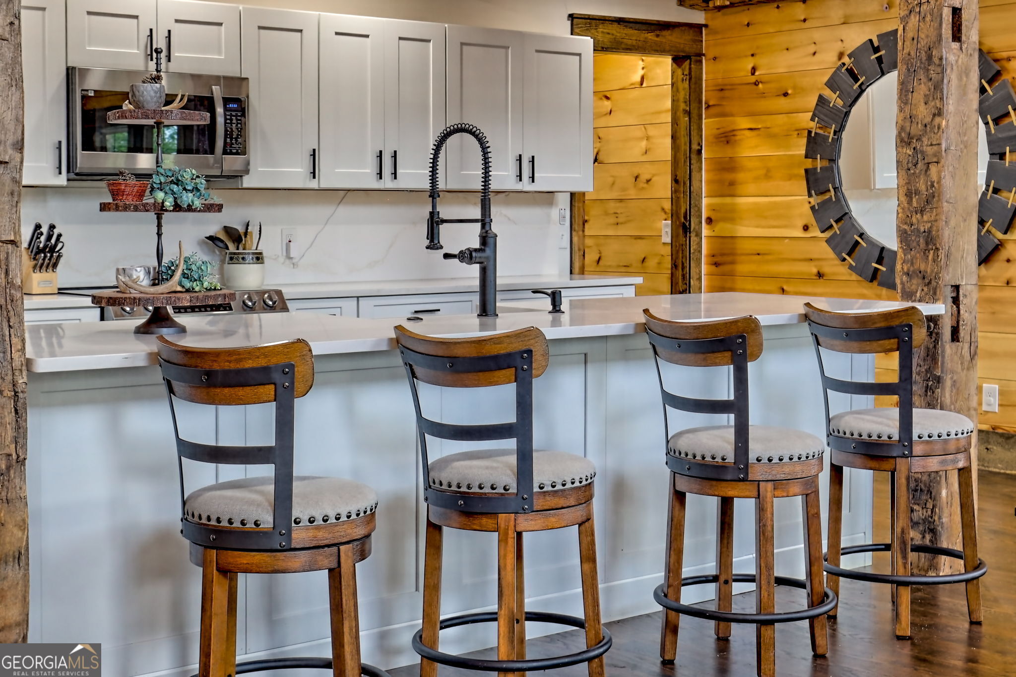 63 Redwood Lane Tiger, GA 30576 - Photo 26 of 84 a kitchen with chairs a sink and a stove