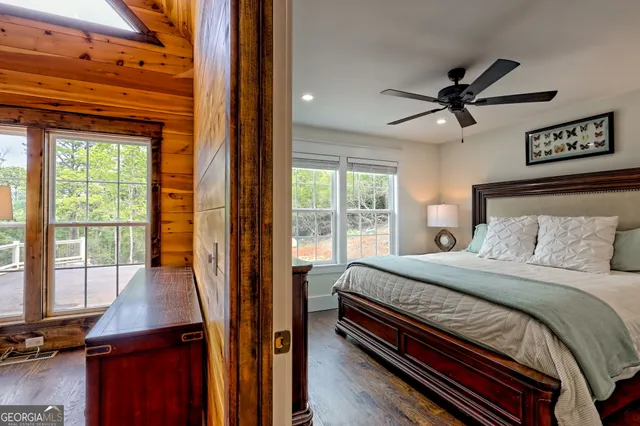 a view of a hallway with wooden floor and furniture