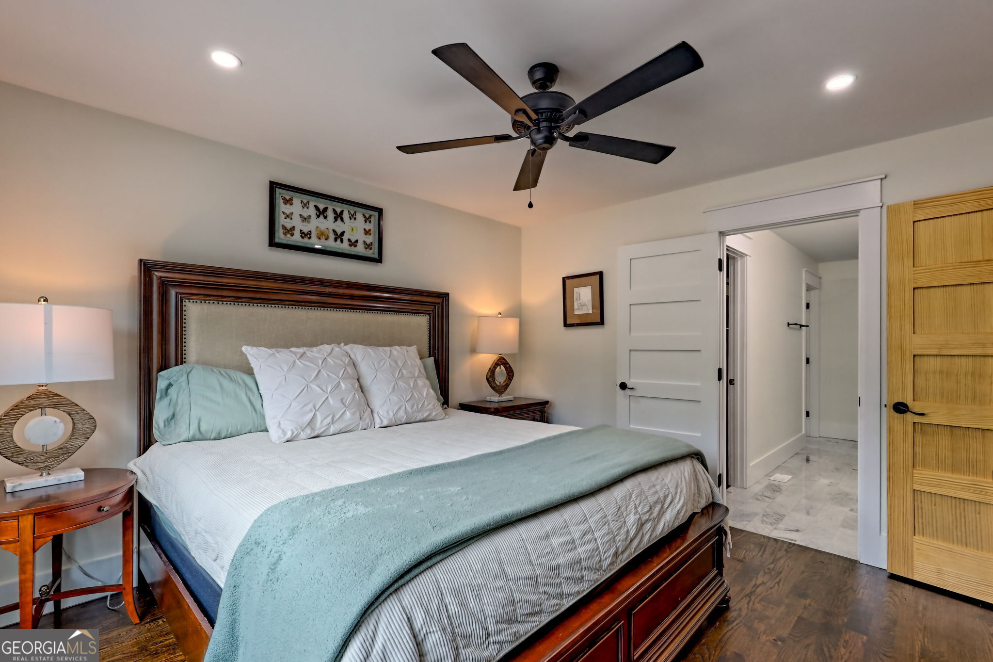 63 Redwood Lane Tiger, GA 30576 - Photo 30 of 84 a bedroom with a large bed and a chandelier