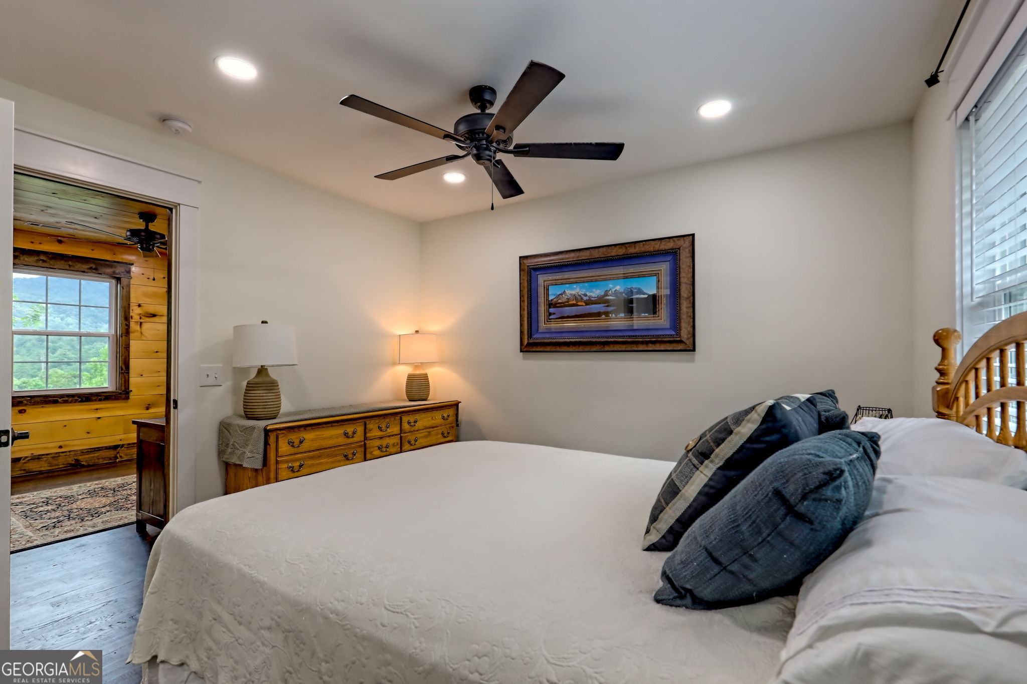 63 Redwood Lane Tiger, GA 30576 - Photo 57 of 84 a bedroom with a bed and a chandelier