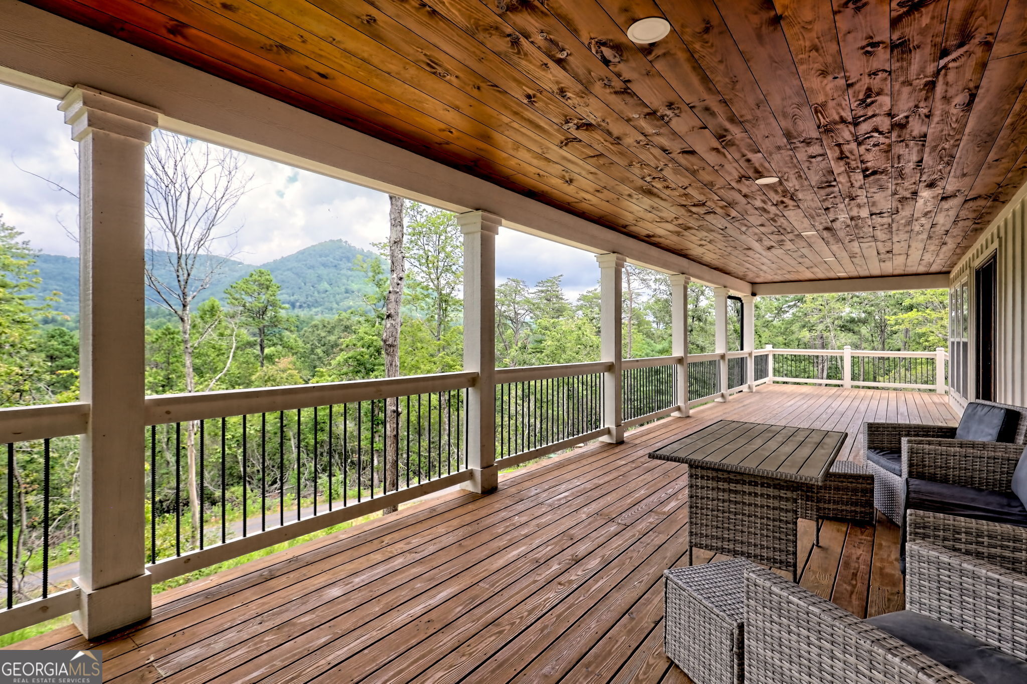 63 Redwood Lane Tiger, GA 30576 - Photo 10 of 84 a view of balcony with couch and wooden floor