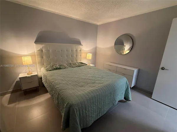 a bedroom with a bed and a mirror