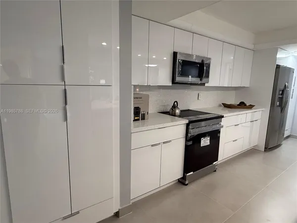 a kitchen with a sink appliances and cabinets