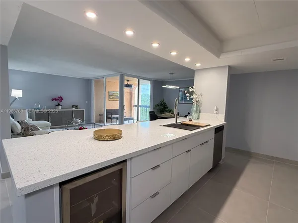 a kitchen with sink a microwave and cabinets