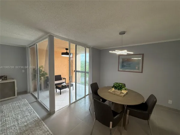 a view of a dining room with furniture and window
