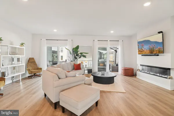 a living room with a fireplace and a wooden floor