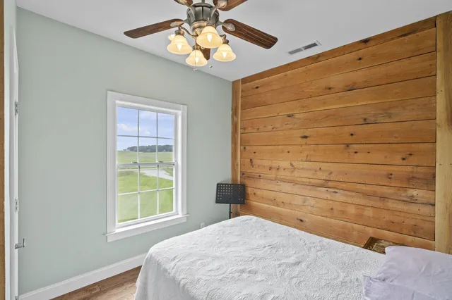 a bedroom with a bed and a chandelier