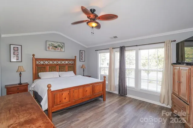 a bedroom with a large bed and a large window