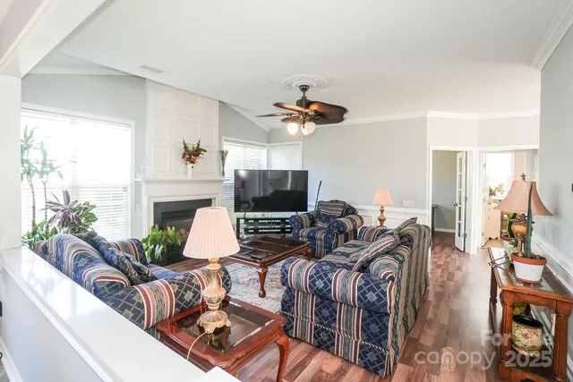 a living room with furniture a fireplace and a flat screen tv