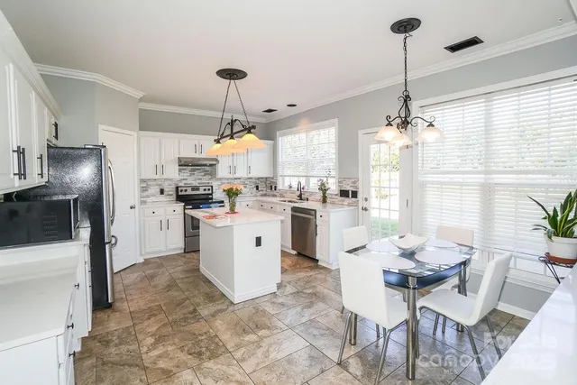 a kitchen with appliances cabinets and furniture