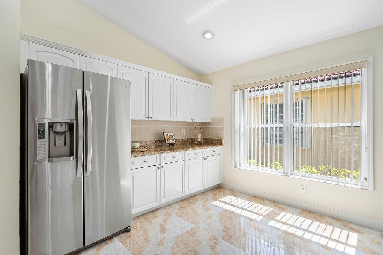 9547 Fox Trot Lane Boca Raton, FL 33496 - Photo 11 of 38 a kitchen with stainless steel appliances granite countertop a refrigerator and a sink