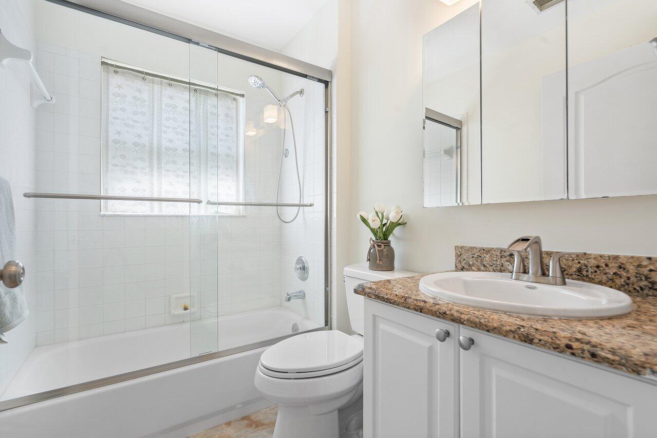 9547 Fox Trot Lane Boca Raton, FL 33496 - Photo 17 of 38 a bathroom with a sink toilet and shower