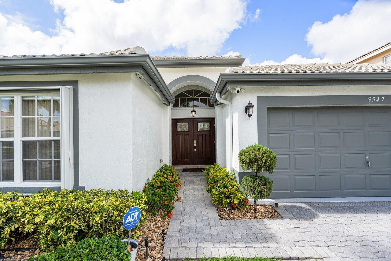 9547 Fox Trot Lane Boca Raton, FL 33496 - Photo 5 of 38 a front view of a house