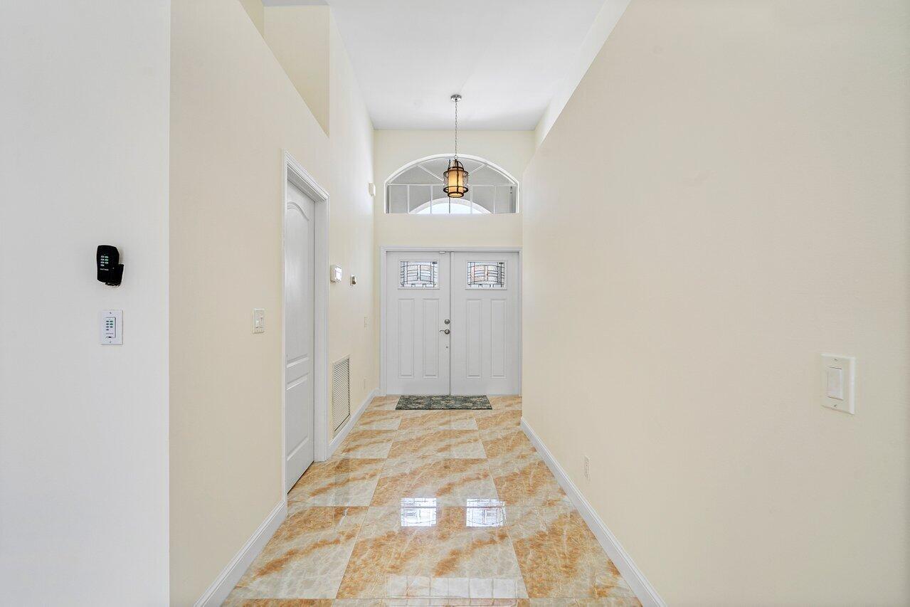 9547 Fox Trot Lane Boca Raton, FL 33496 - Photo 6 of 38 a view of a hallway to a bedroom