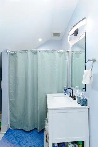 a bathroom with a sink a mirror and a shower