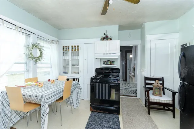 a living room with furniture a rug and a window