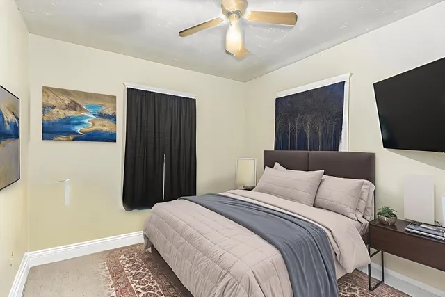 a bedroom with a bed and a painting on the wall