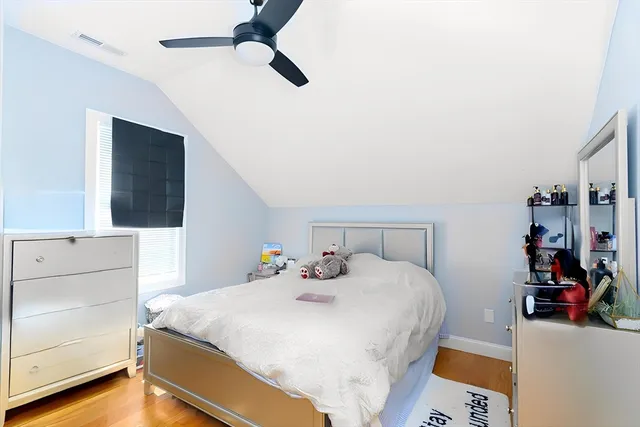 a bedroom with a bed and a dresser